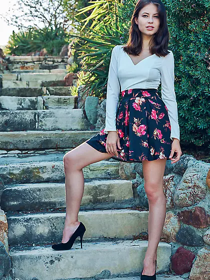 Flowery skirt brunette shows her red panties and her soft pussy