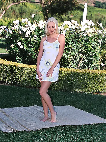 Seductive blonde gal Alana Evans strips her white gown outdoors