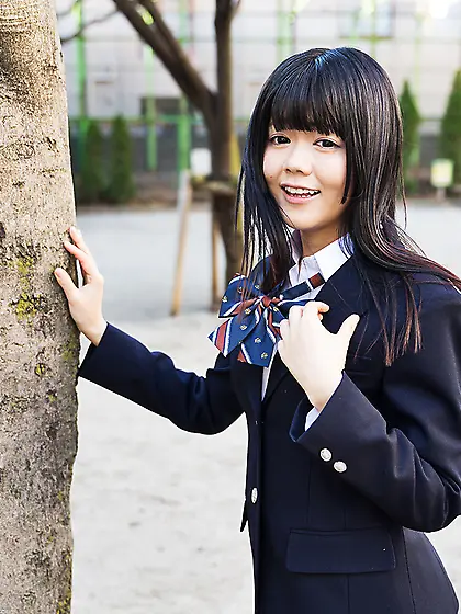 Young Japanese girl gets naked looking into the camera with her