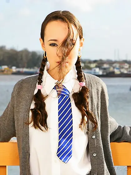 Flat chested schoolgirl Laura J in pigtails does strip tease on