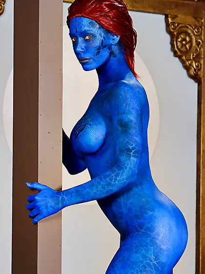 This redhead slut with a painted body gets down to please two we