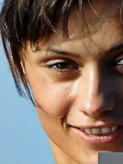 Brunette babe Atena A is naked in the water covering the body wi