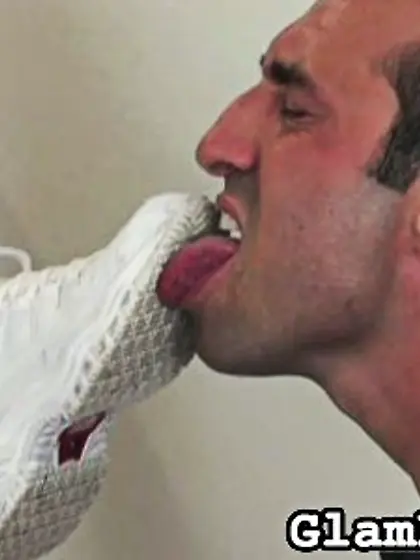 Sexy gal shoves stockinged feet in a man’s...