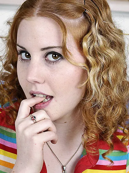 Playful Cherry Poppens strips out of her thong panties and sprea