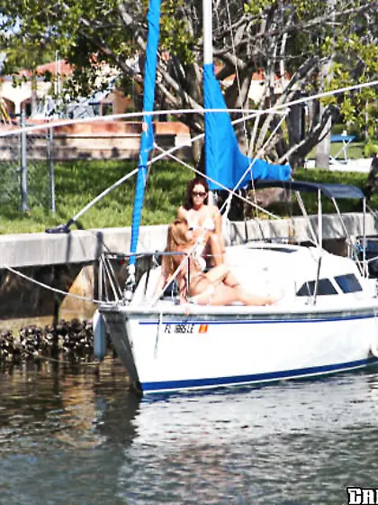 Thick blonde in a white bikini getting banged by two hung dudes