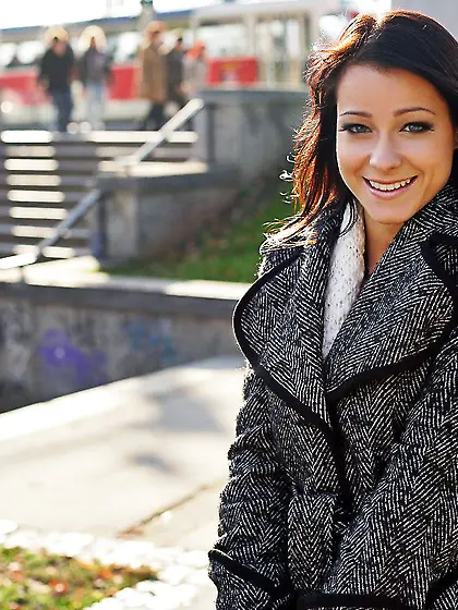 Smiling brunette girl Stracy Stone in skirt and coat flashes her