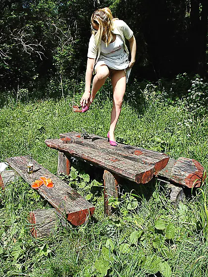 Pissing outdoor deep in the forest on the old table