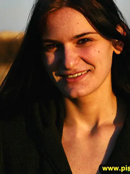 Outdoor pissing of a cute teen brunette