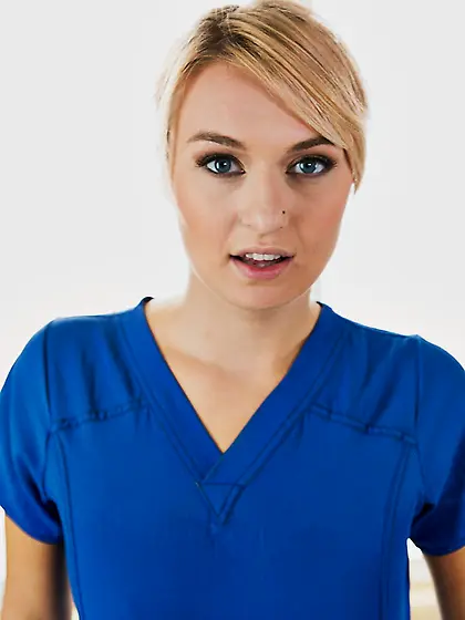 Female in a blue massage suit meets another client being complet