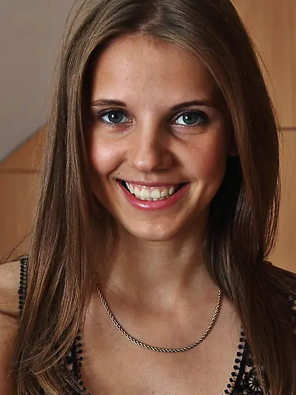 Dark-haired beauty teasing her pussy next to her gym equipment