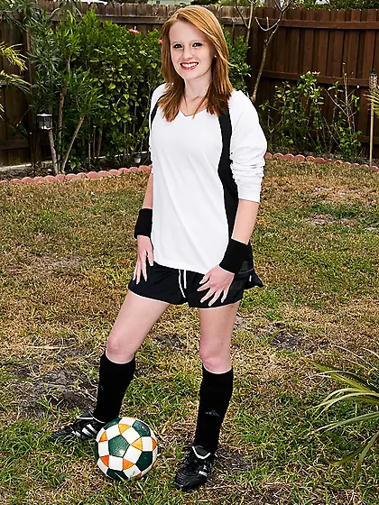 Red-haired soccer girl Katey Grind strips in the field and gives