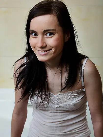 Girl washes soapy body and masturbates shaved pussy using dildo