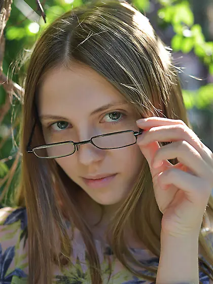 On a sunny day skinny bookworm finds quiet spot near reeds and t
