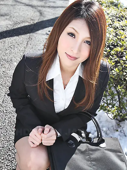 Redheaded Japanese girl in suit poses to show her beautiful face