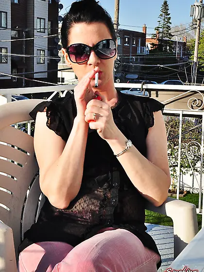 Brunette babe smoking at the terrace