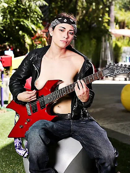 Half-naked guitar player performs