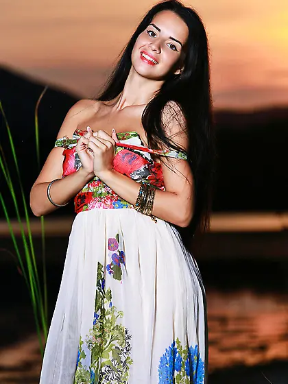 Tanned brunette takes off her summer dress to pose outdoors,  in