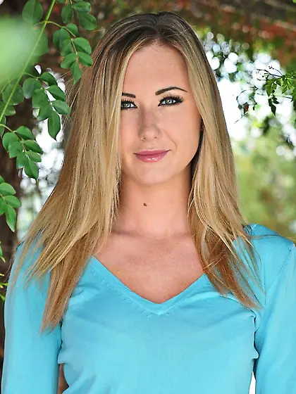 Lovely blond lassie in stockings doffs clothes to showcase perky