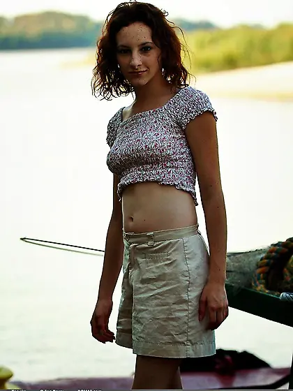 Slender girl with curly red hair and hirsute pussy undresses for