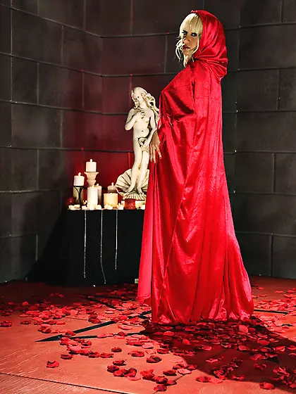 Blonde witch in heels slowly removes red gown and poses naked on