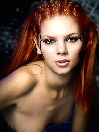 Sexy ginger poses in kinky outfit for Sinful Goddesses.