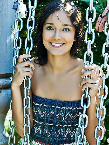 The brunette teen Chandra A has sat on the stairs and showed the