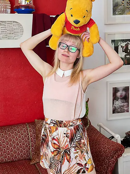 Geeky blonde with a hot body shows her hairy crotch on couch