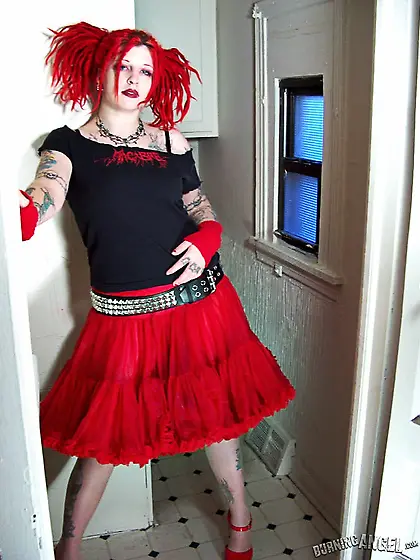 Fetish chick with flaming red hair spreads her chubby pussy wide