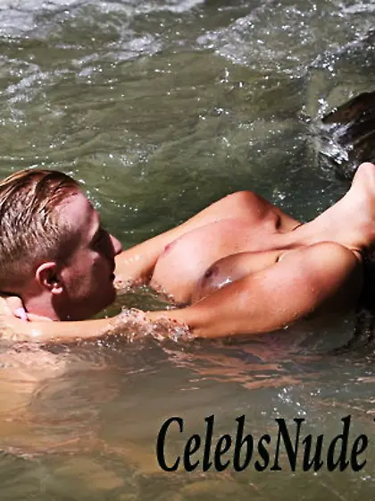 Busty Jordan caught topless under a waterfall