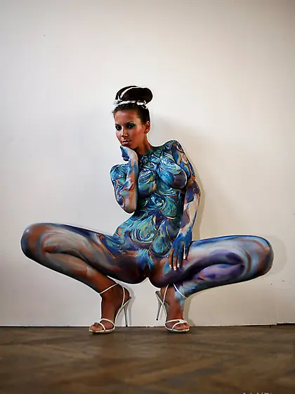 Bodypaint brunette beauty showing off her painted holes on all f