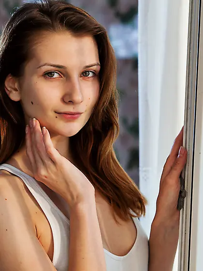 Oversized white t-shirt brunette slowly getting naked in a sun-l