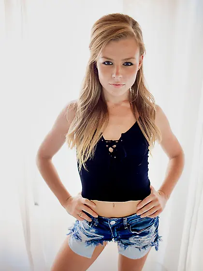 Petite sweetie poses in denim shorts then pulls them down to spr