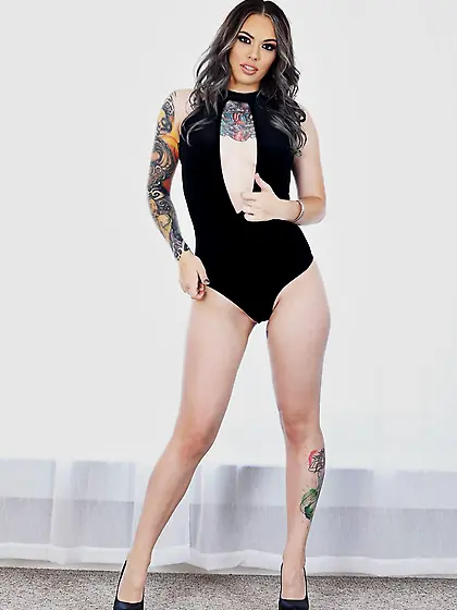 Tattooed MILF relaxes by the window with no clothes but in black