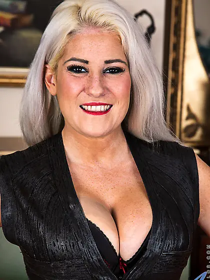 Pornstar with grey hair knows her way around stripping and looki