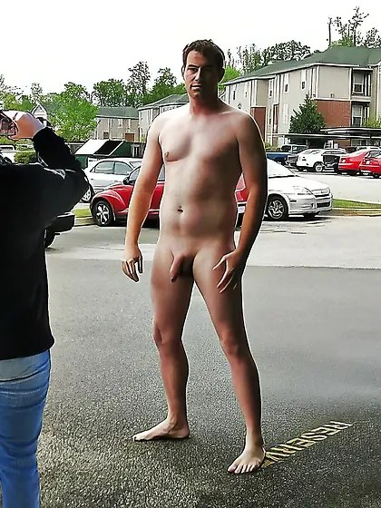 naked man in carpark getting photographed