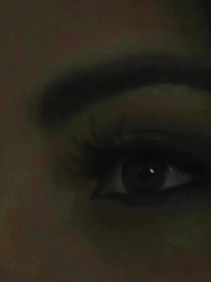 Wavy-haired brunette turned reflection