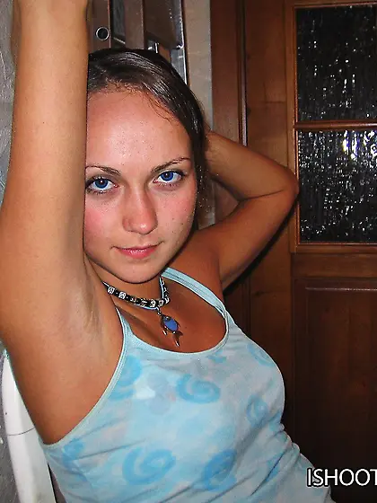 Girl in blue lingerie and high socks tries to pose quiet not to