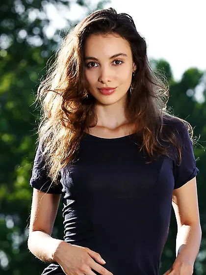 Young Latina with a winning smile seduces the viewer with her bo