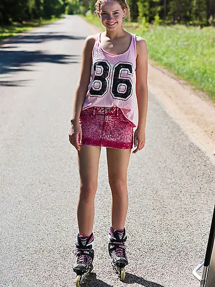 Young blonde girl Faina Bona enjoys getting naked on roller blad