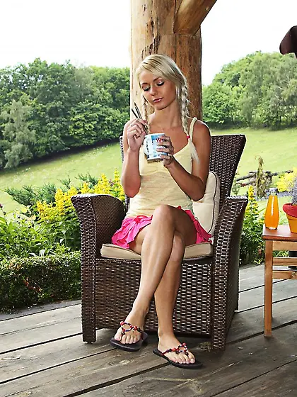 The shaved pussy lips of hot blonde Pinky June are stretched apa