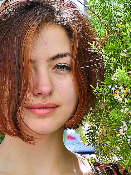 Dirty redhead unclothes natural boobs with pale nipples in a for