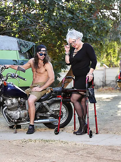 Grey-haired old woman with glasses undresses trying to seduce yo