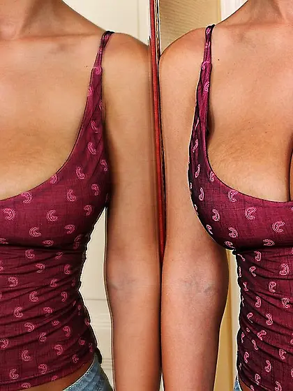 Tanned brunette with big natural tits masturbating on the floor