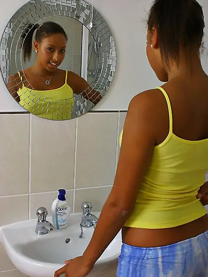 Ponytailed ebony teen Amy-Lou displays her shapely tits while st