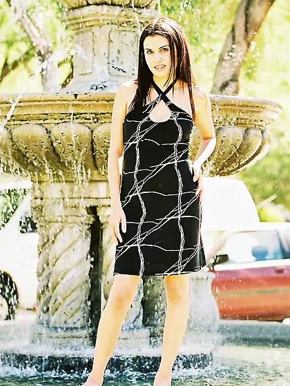 This elegant young babe in a black dress reveals her sex appeal.