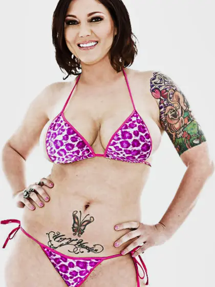 Smiling MILF with tattoos can't hide big melons and fanny under