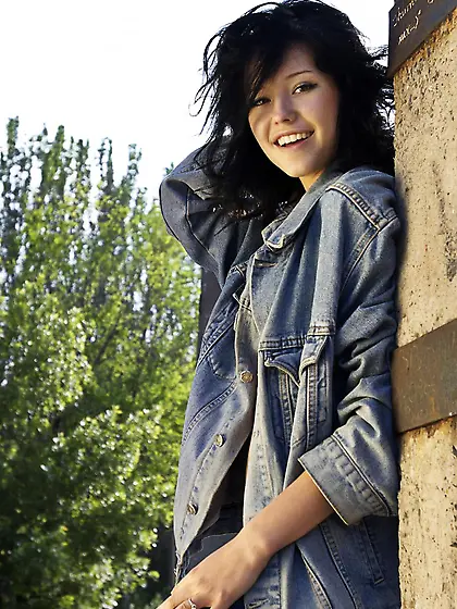 Naughty brunette doll Eleonora B strips and has fun outdoors pou