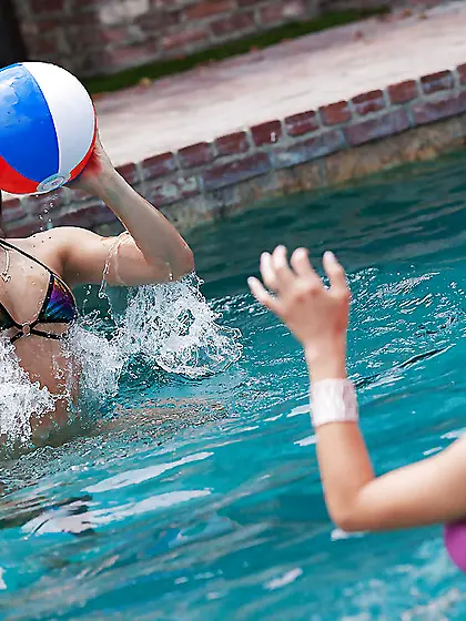 Girls play with a ball in the pool and strong sexual desire fill