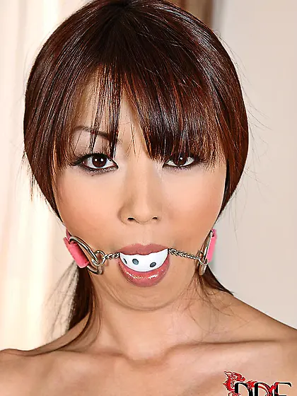 Naked Japanese beauty poses in handcuffs and with ball gag insid