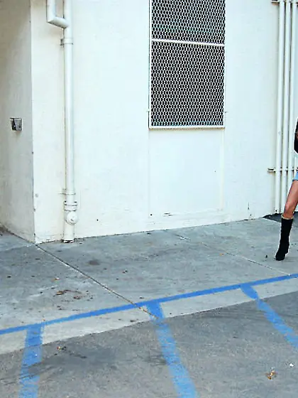 Busty exotic babes sharing a double-sided dildo on a white couch